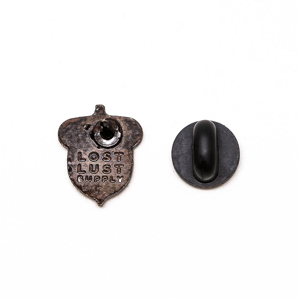 Back of an acorn die-cast bronze enamel lapel pin with rubber clutch, by Lost Lust Supply.