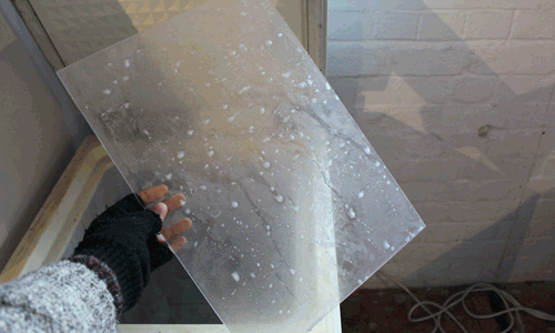 The poster was made by freezing water on acrylic glass to capture the ice, frost and condensation of the Smoky Bay.