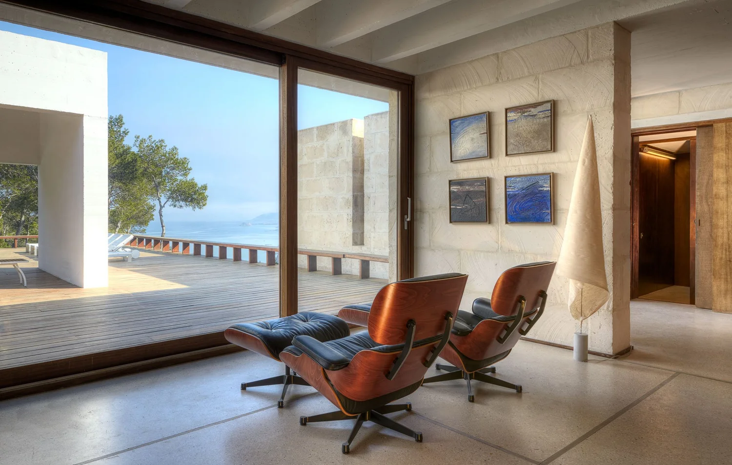 Living room at Casa Tagomago with two lounge chairs and sea views from the terrace.