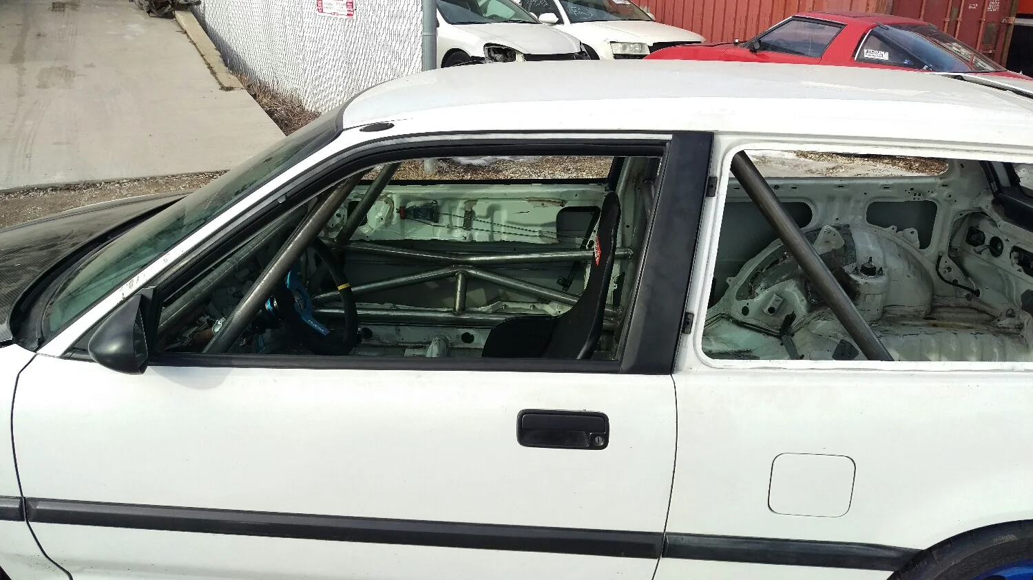 the door bars here are a sill-bar/protruding-X design, and I've seen Mike use this on a few cars. its a pretty well thought out design, with a lot of load paths for the force to travel in the event of a T-bone or sliding into a wall or tree. These bars nearly touch the factory door bars inside the door as well. 