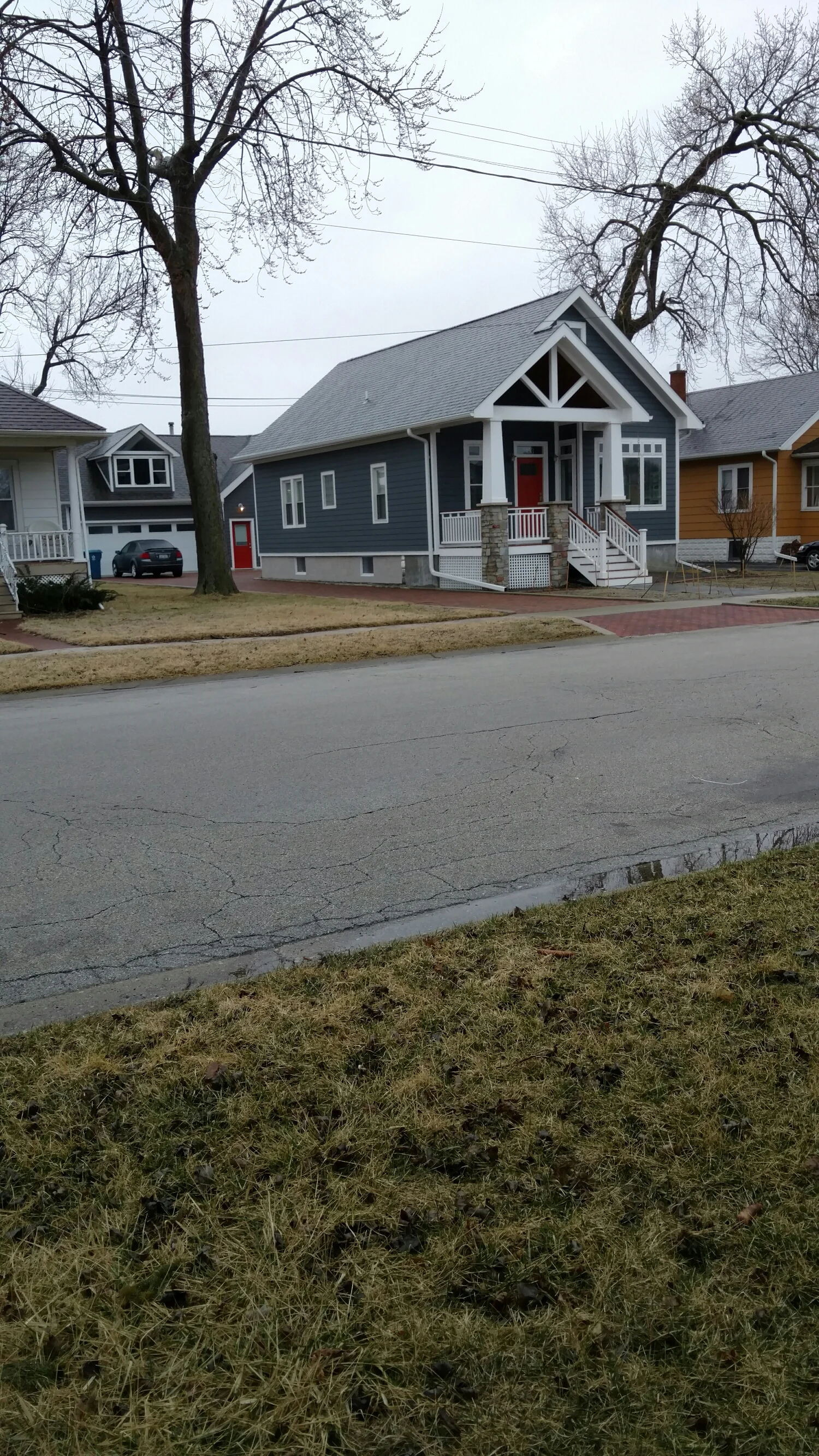 A simple suburban neighborhood is the backdrop for this house, and it fits in just fine. 