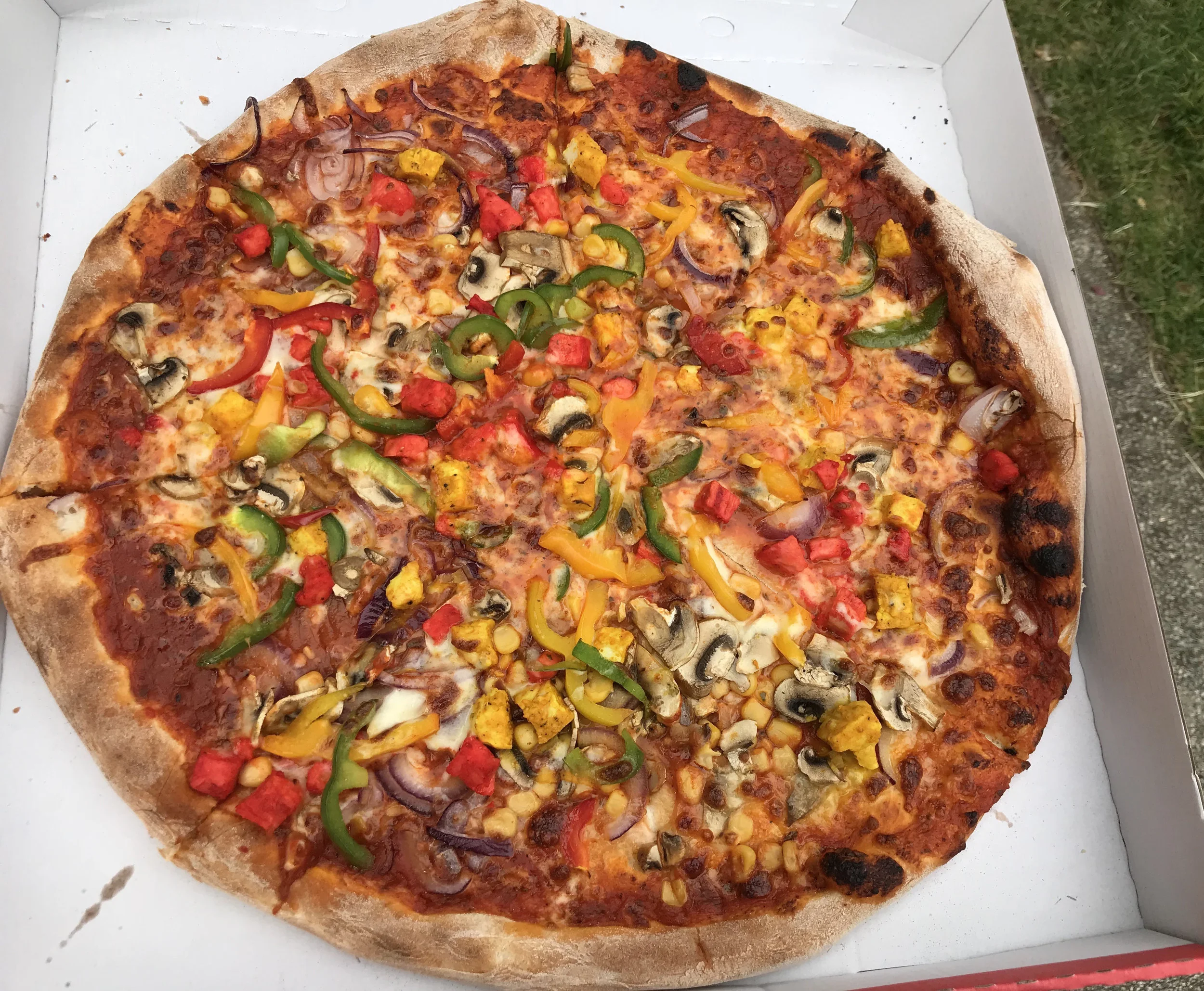 Heavy on the topping. A chicken and mixed pepper combination.