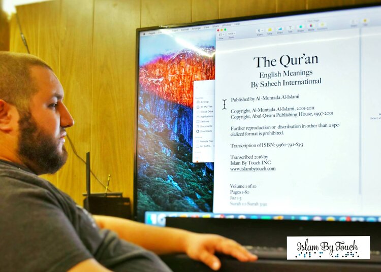 Nadir at a computer screen opening up a translation program to begin printing of Volume 2 of the complete set of the Quran.