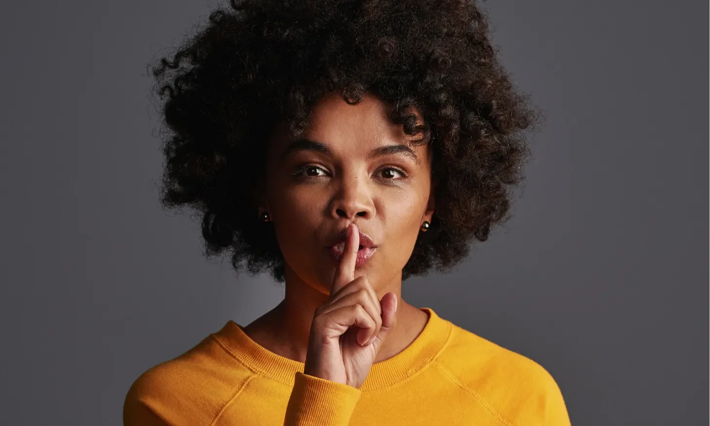 black woman in yellow shirt