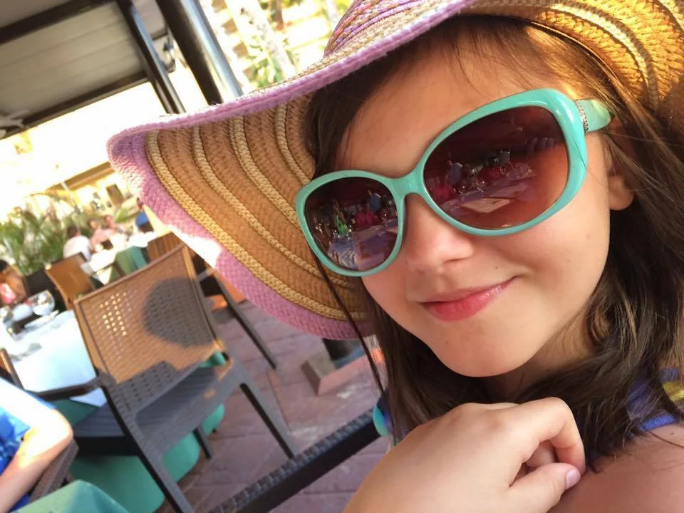 TrizCom Public Relations girl in hat and sunglasses