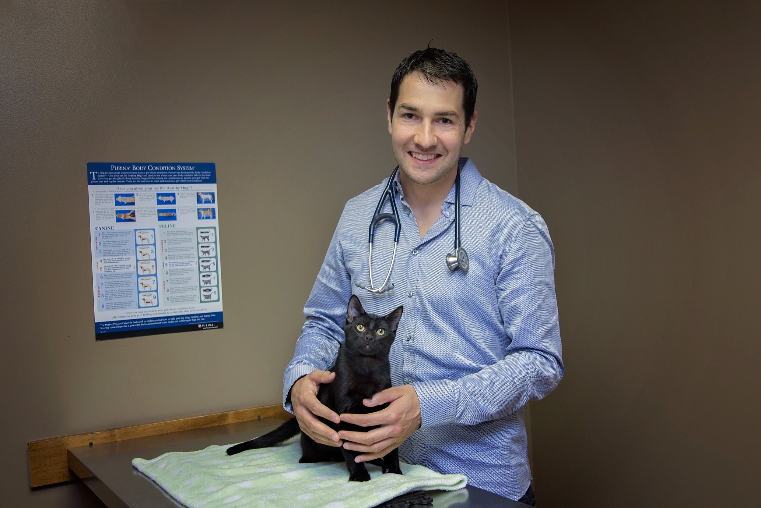 Dr. Mike Bugg (Veterinarian, Cumberland Veterinary Clinic) poses with the handsome Balish for the 2017 Men With Cats Calendar.