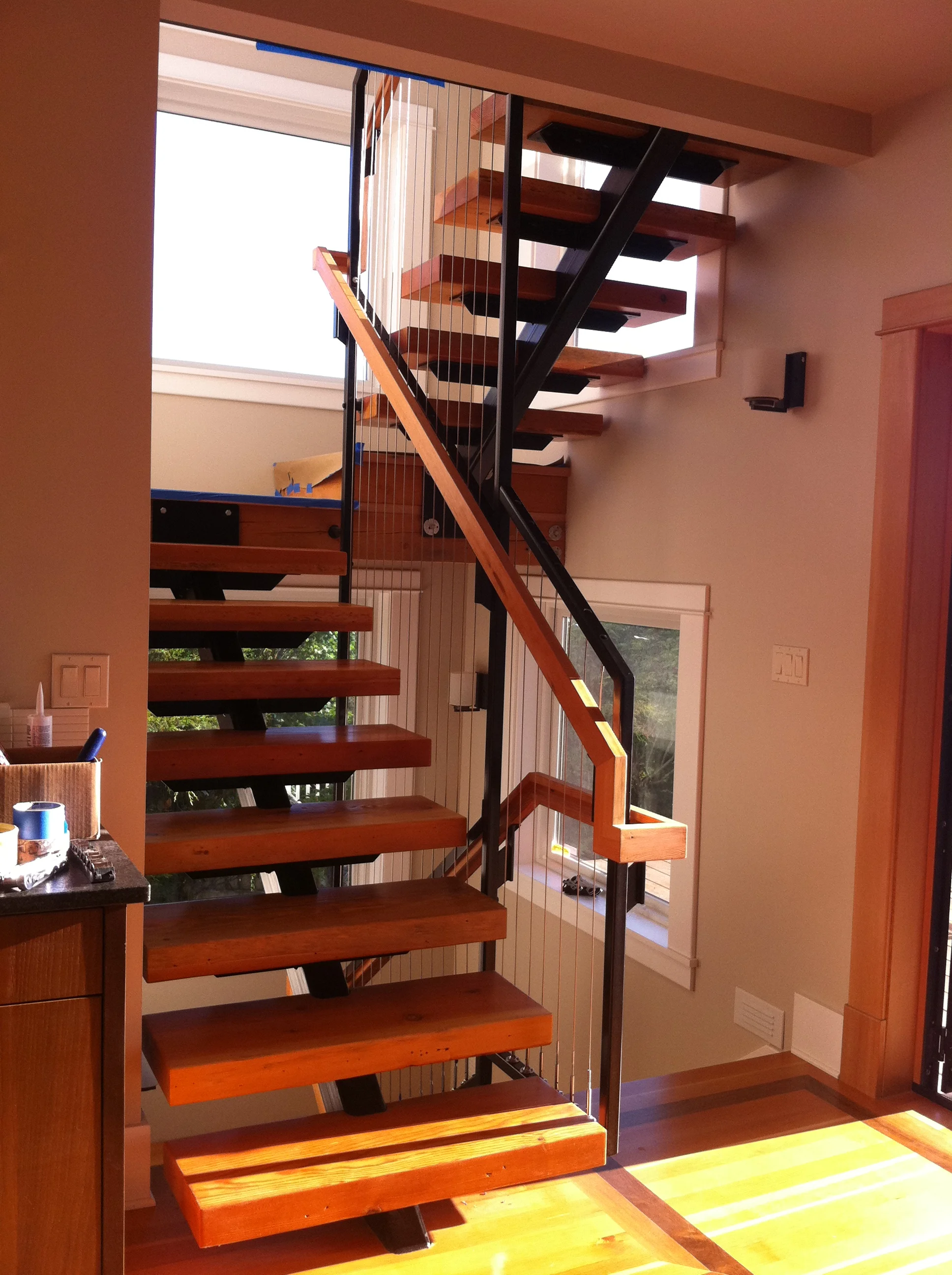 Continuous black powder coated steel framework extending through three stories.