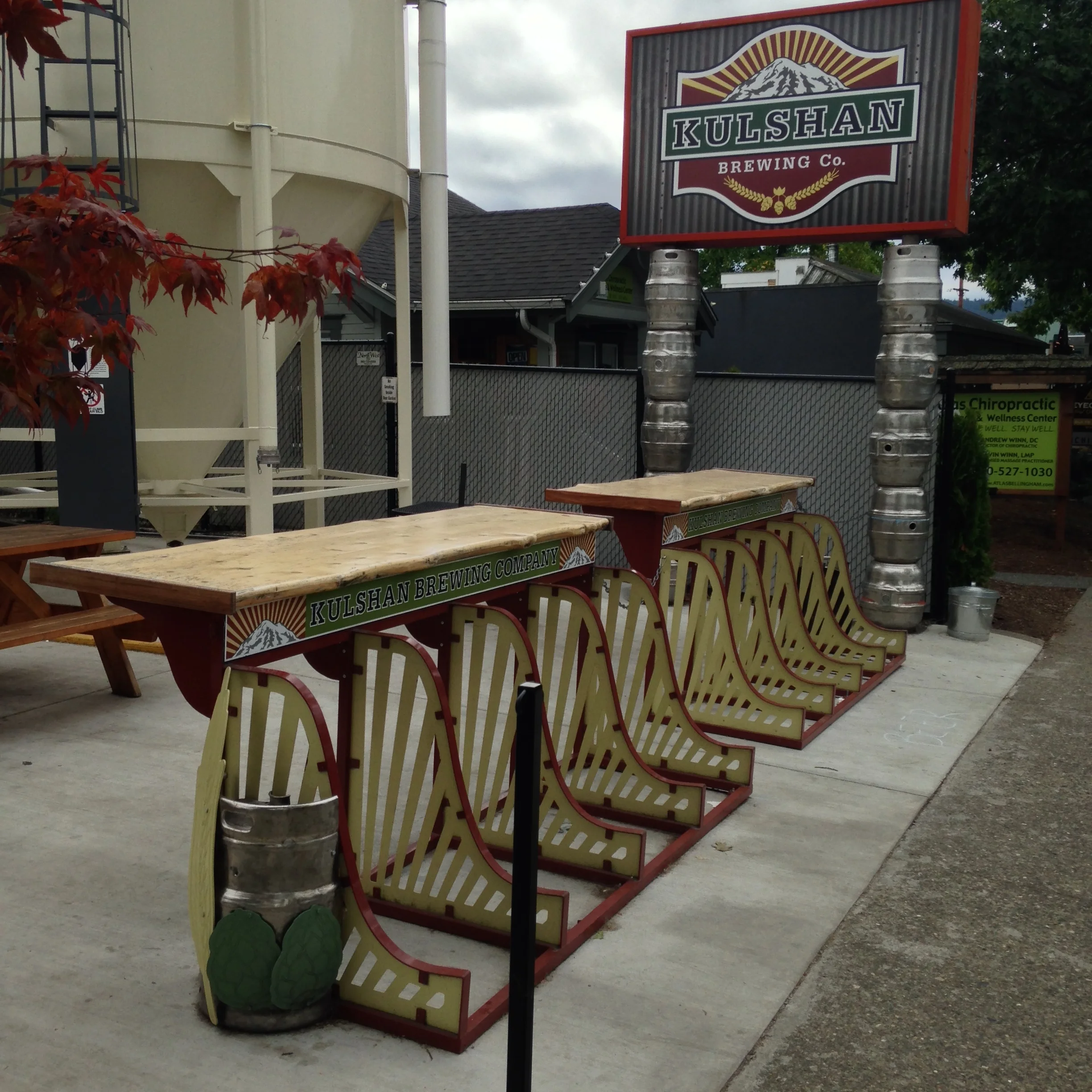 Bike rack, bar, railing, advertising, sculptural end caps, logo design elements, matched color scheme....all in one.