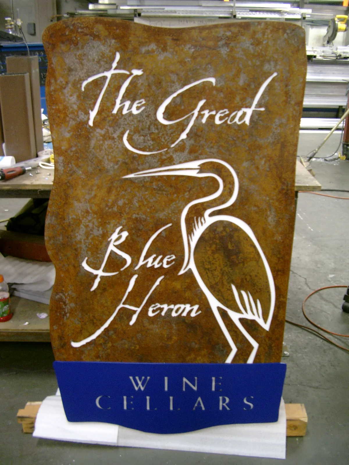  Routered aluminum, plasma cut steel, white polycarbonate, rust patina, blue paint. 