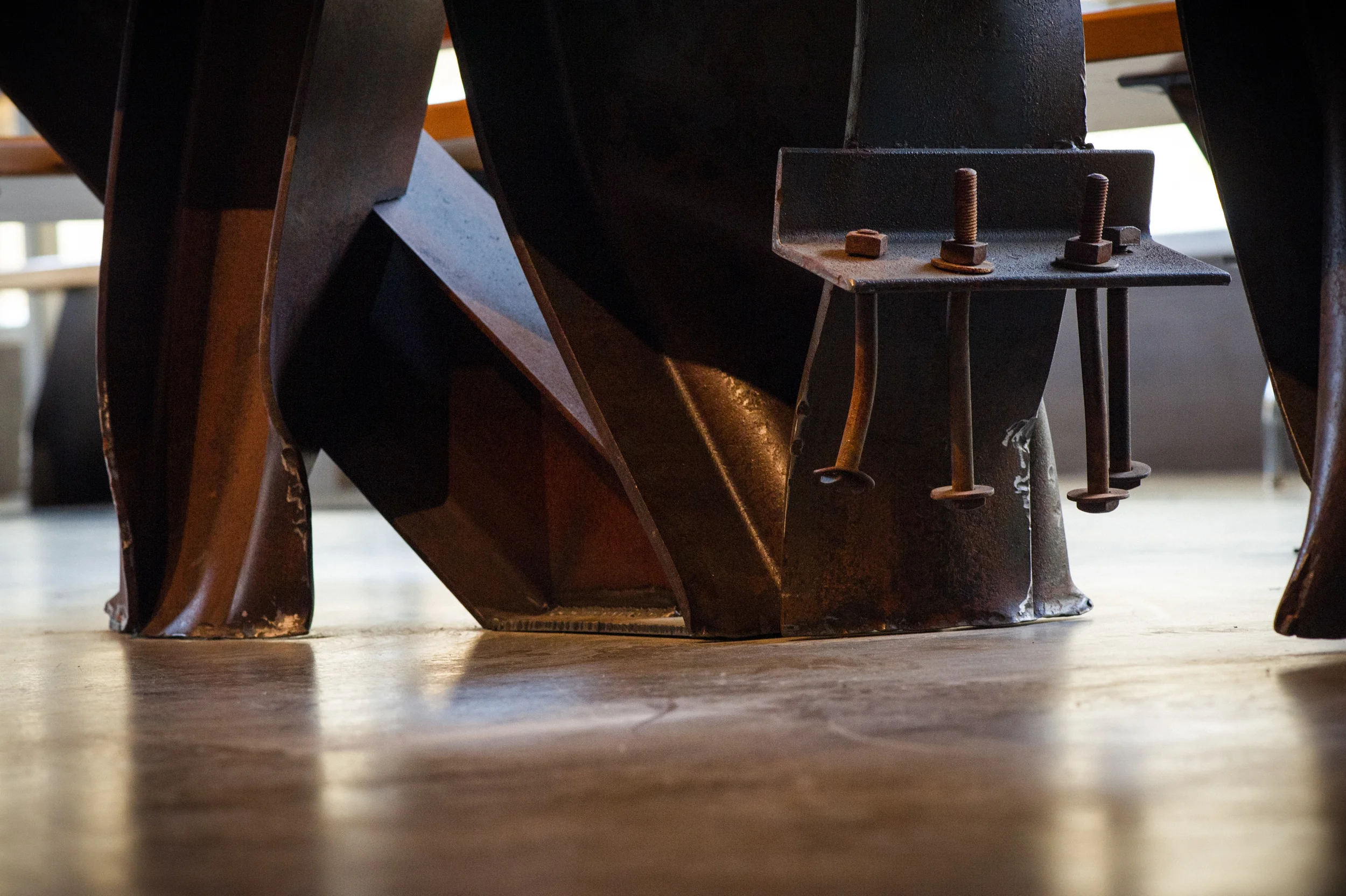 The sheared flanges meet the floor with a minimum of visible attachment.