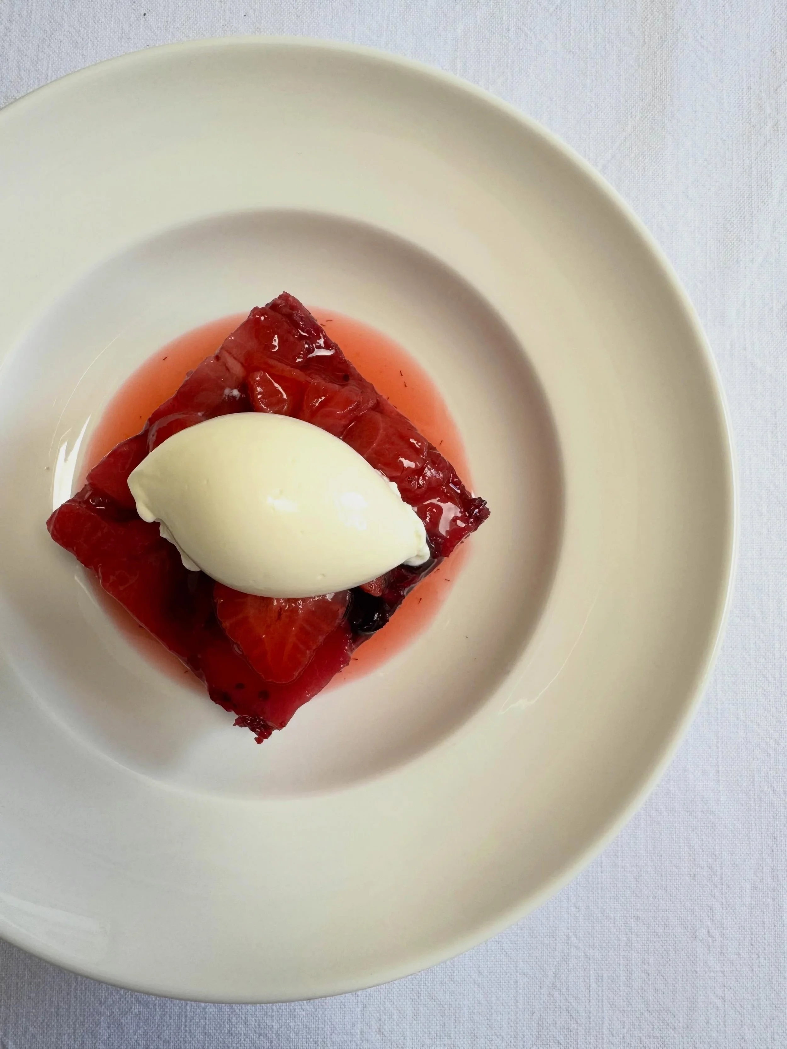 Our summer pudding is new to the menu this year and I&rsquo;m in love. We make a blackcurrant and raspberry compote steeped with lemon peel, then sandwich this between 2 layers of vanilla genoise sponge and top with roasted Cheddar strawberries. Serv