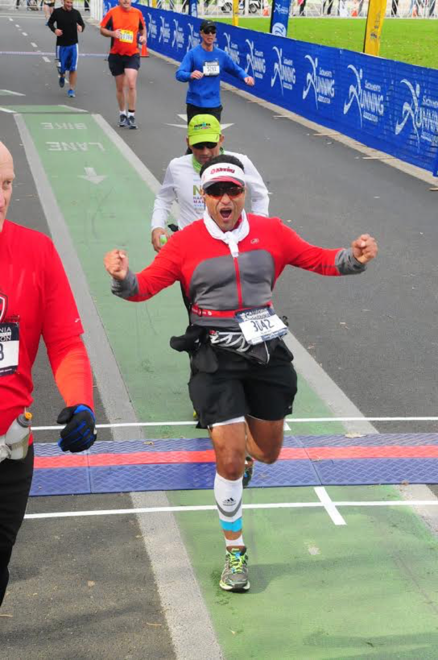 Albert D. at CIM December 2016, powerful expression after crossing the finish line of his first marathon