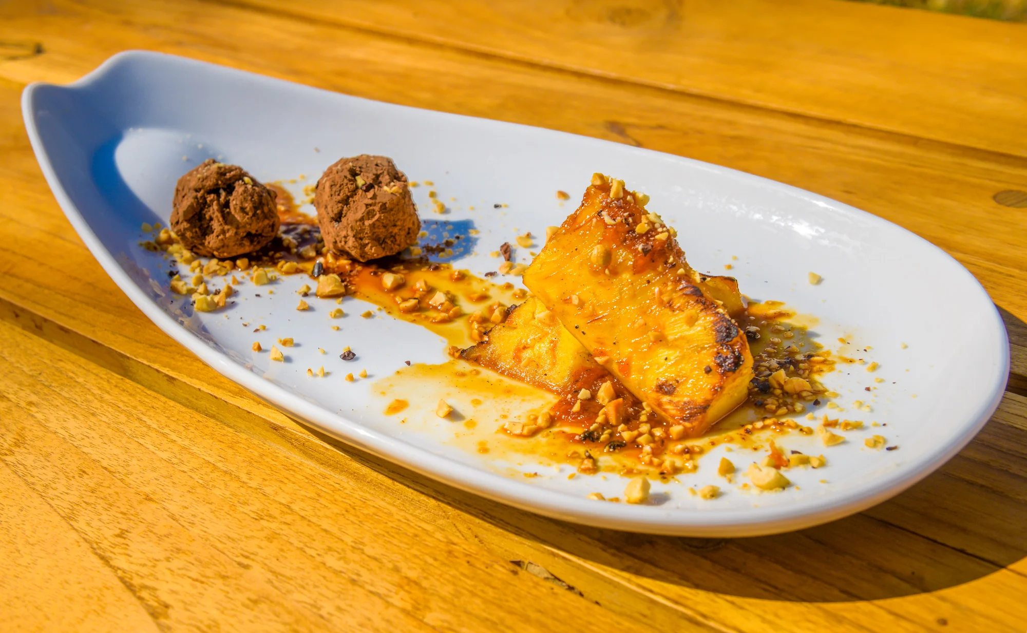 Pineapple-red-grapefruit-ruhm-flambe-with-raw-chocolate-truffle-and-crushed-peanuts-SIDE.jpg