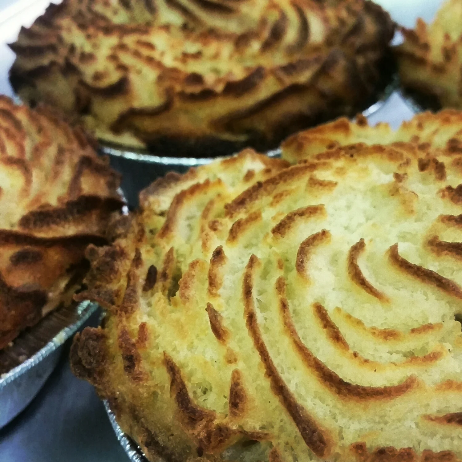 Beef Shepherd's Pie - beef & Guinness stew with mushrooms, carrots, and peas in a butter crust topped with a swirl of our homemade mashed potatoes. 