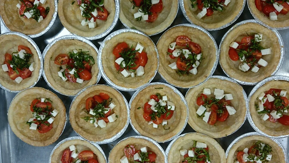 Quiche with tomato, basil, & mozzarella; before we fill it with the quiche custard & gruyere cheese and top it with the crispy bacon... The staff's favorite quiche! 
