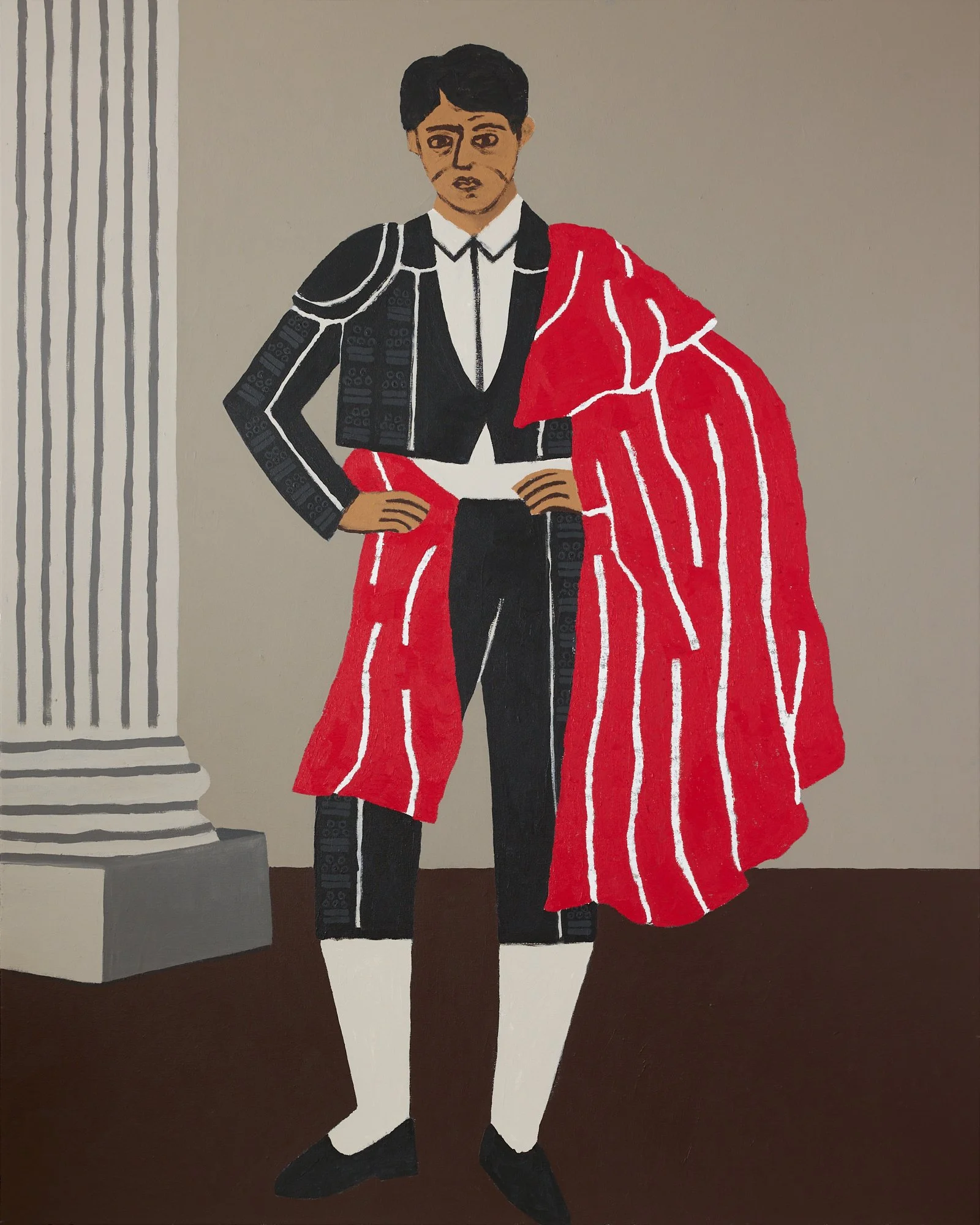 A PORTRAIT OF JOSE GOMEZ ORTEGA (JOSELITO) A BULLFIGHTER STANDING IN FRONT OF A STONE PILAR WITH HIS RED CAPE DRAPED OVER ONE SHOULDER