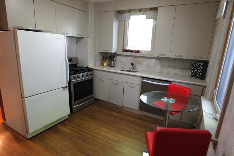 The kitchen features modern cabinets and newer granite countertops.