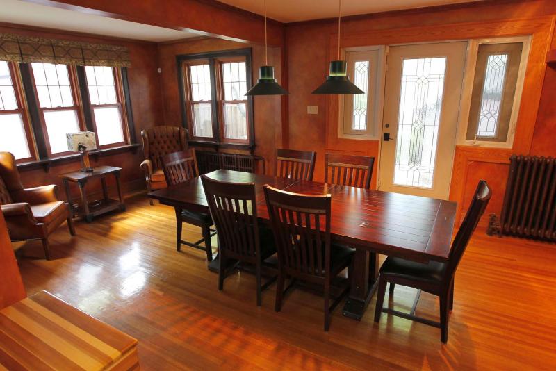 The formal dining room features faux-finished terra cotta walls and is surrounded by five windows.