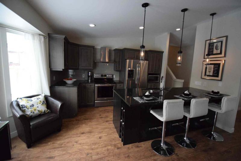 TODD LEWYS / WINNIPEG FREE PRESS/A large island provides separation between the kitchen and dining area.