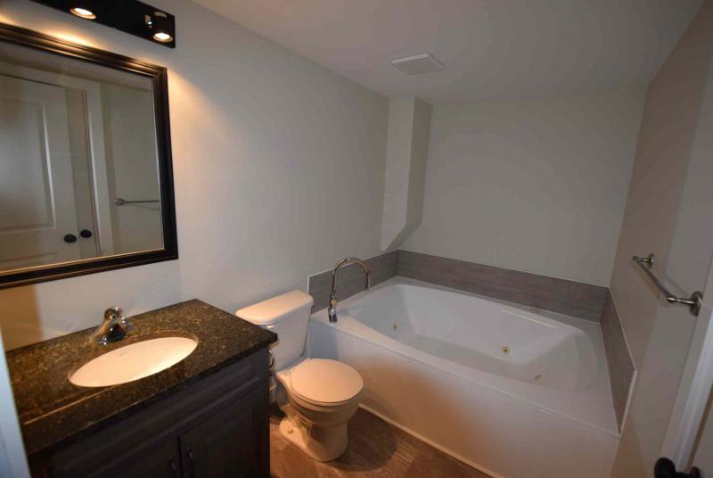 TODD LEWYS / WINNIPEG FREE PRESS/The ensuite on the mid-level is a great spot to relax with a jetted soaker tub surrounded by rich finishes.
