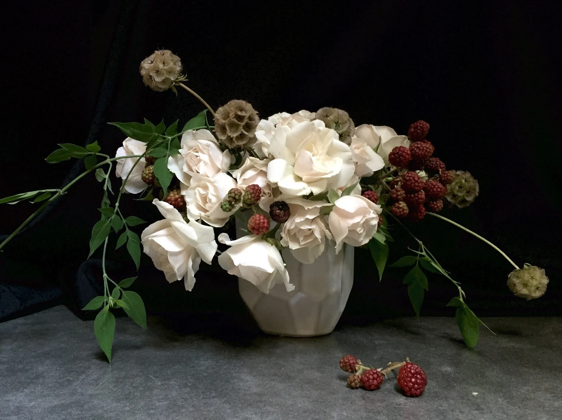 Small romantic arrangement with Vivienne roses, blackberries, scabiosa pods
