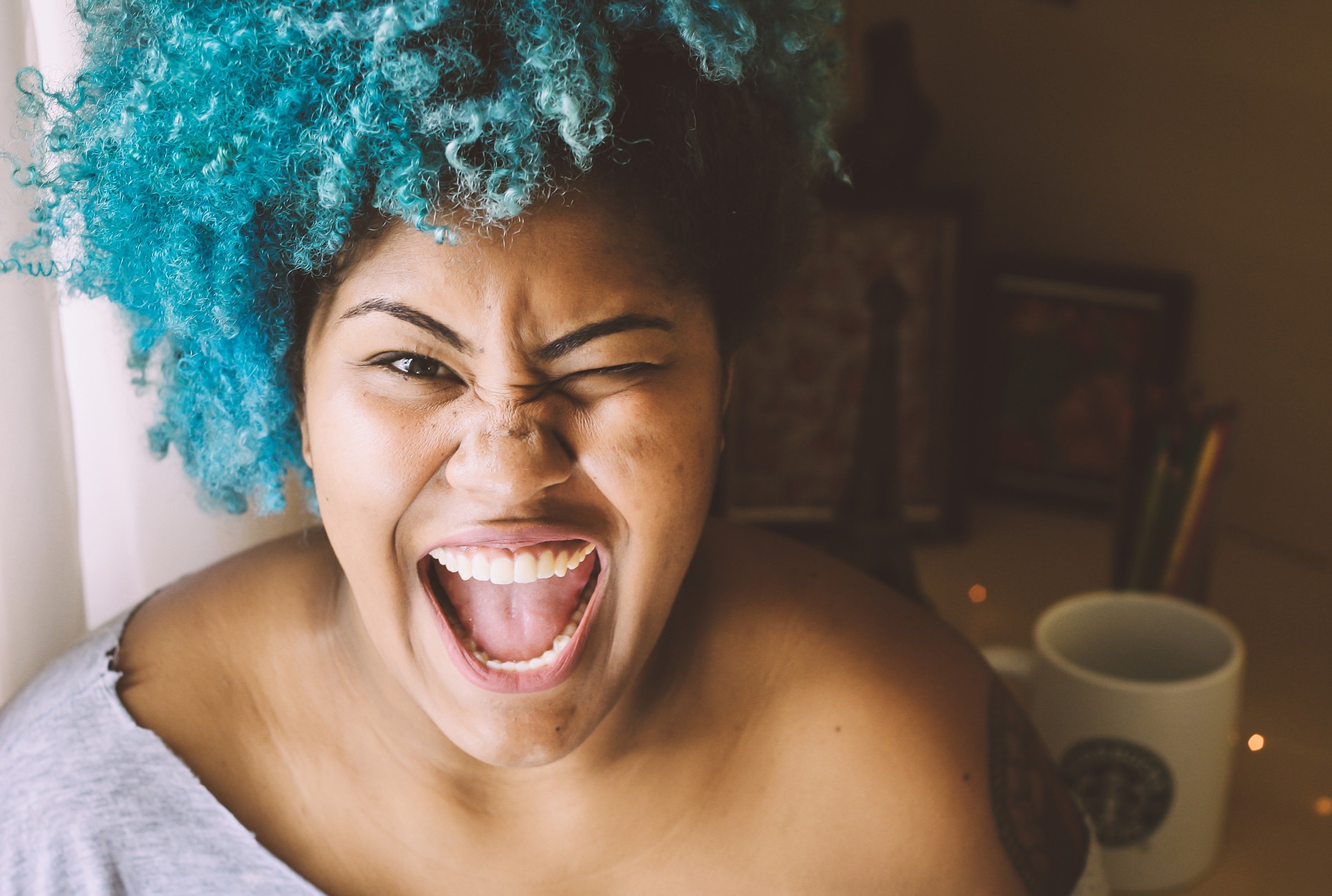 Happy-Black-Woman-smiling-white-Starbucks-mug.jpg