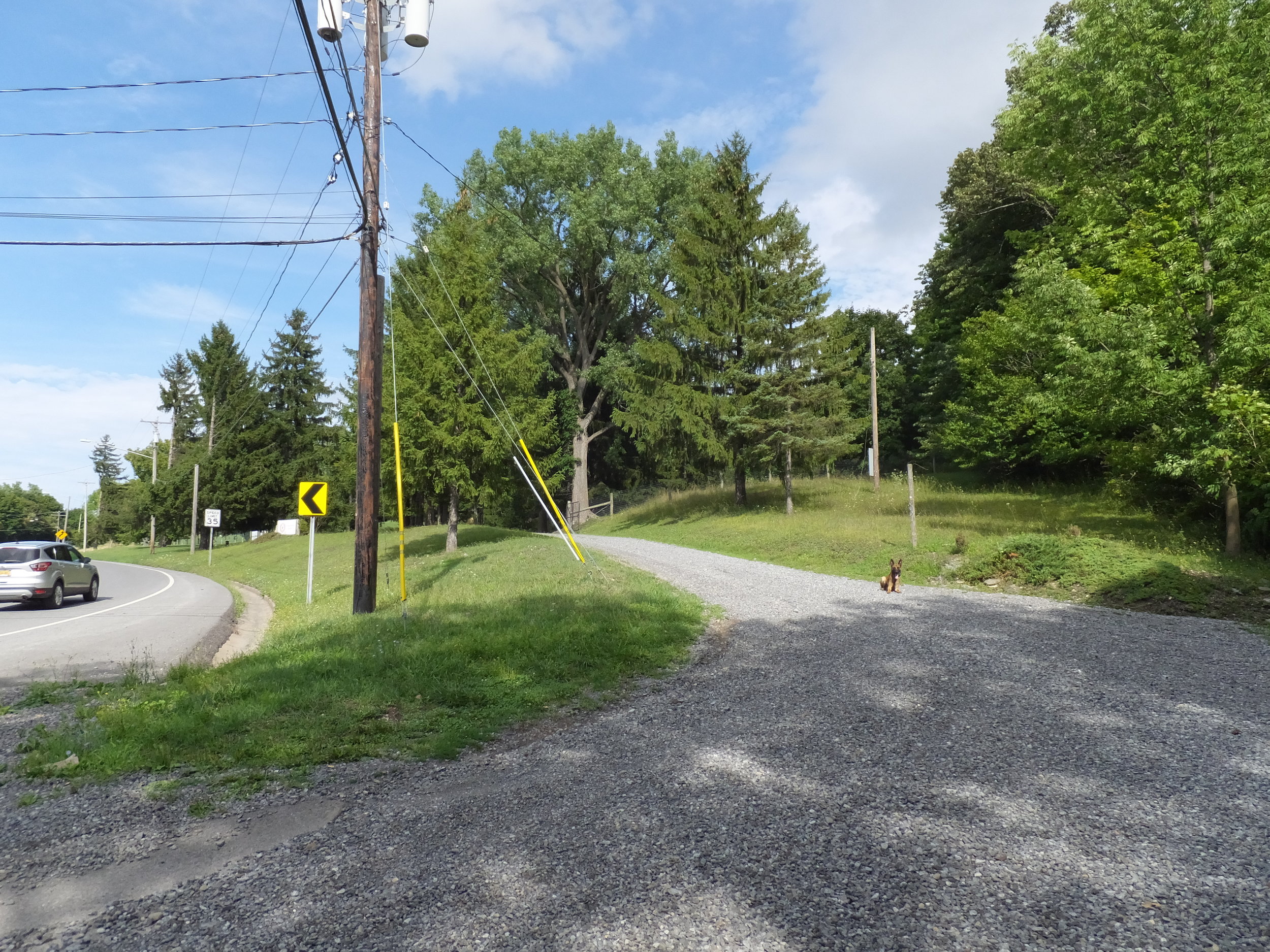 Driveway located directly off of West Genesee Street just before or after (depending on direction of travel) Monroe Road at the bottom of the hill.