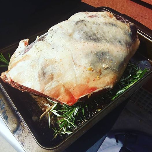 BBQ Roasted lamb on a stack of fresh rosemary