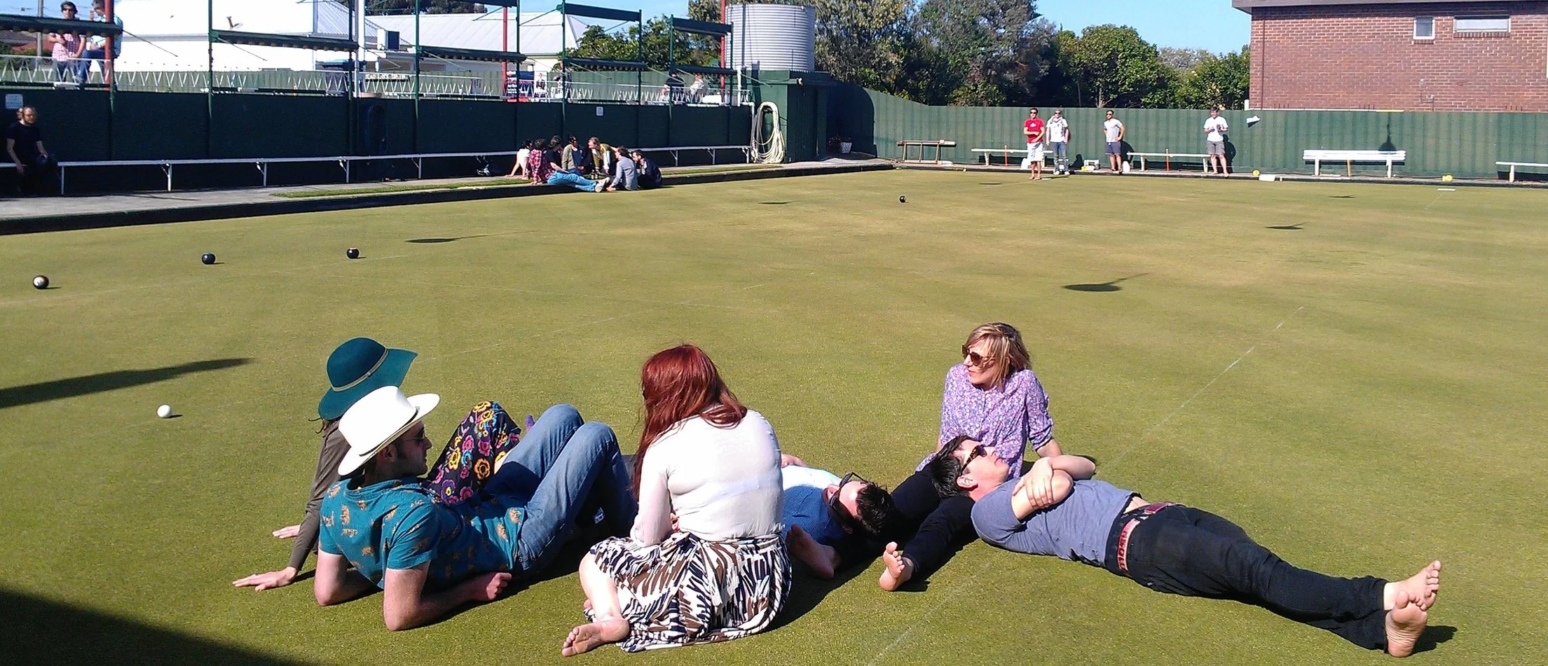 Barefoot bowlers enjoying sunshine on the green.jpg