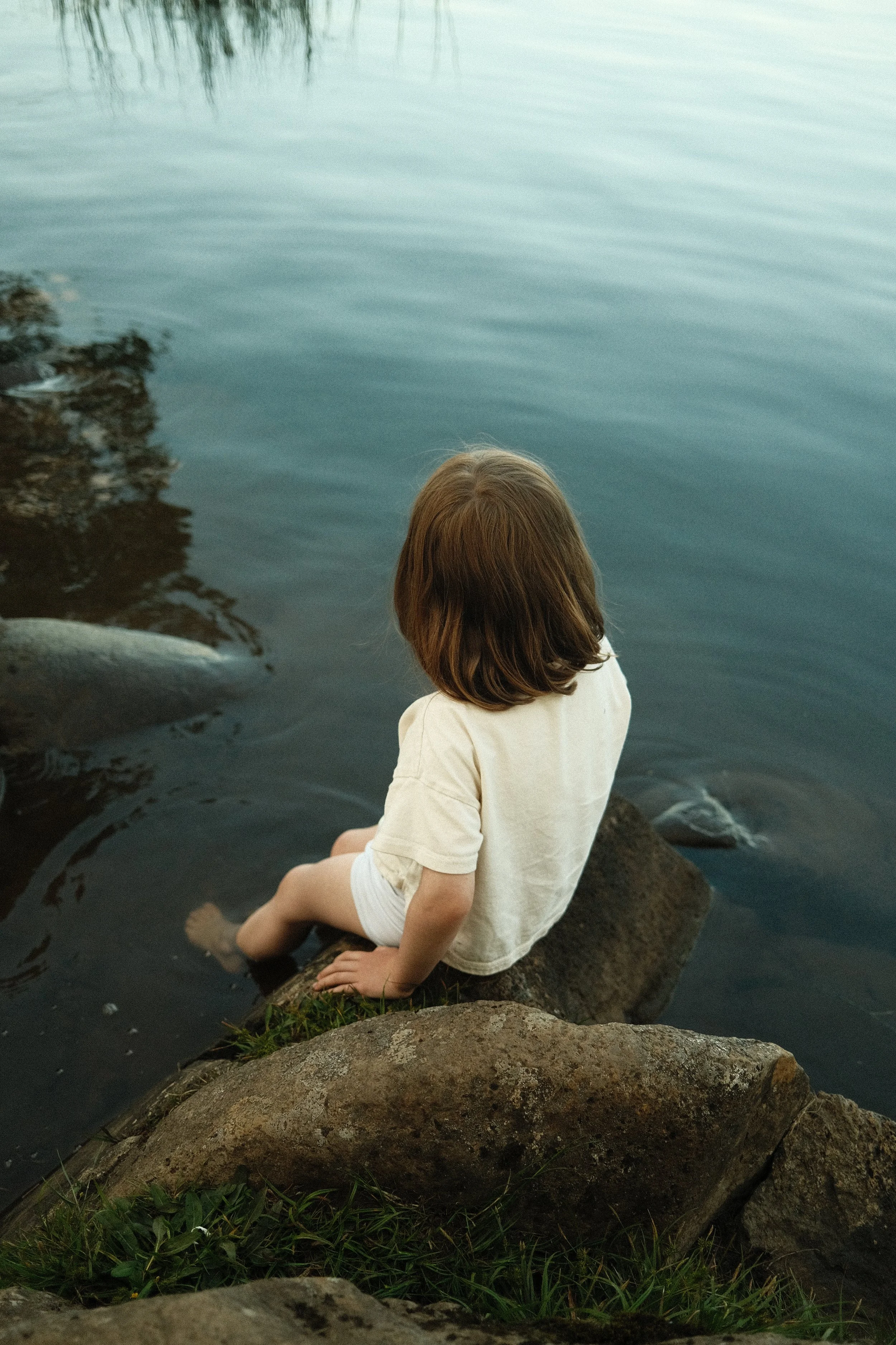 Scottish loch water reflecting late summer golden hour sunlight.