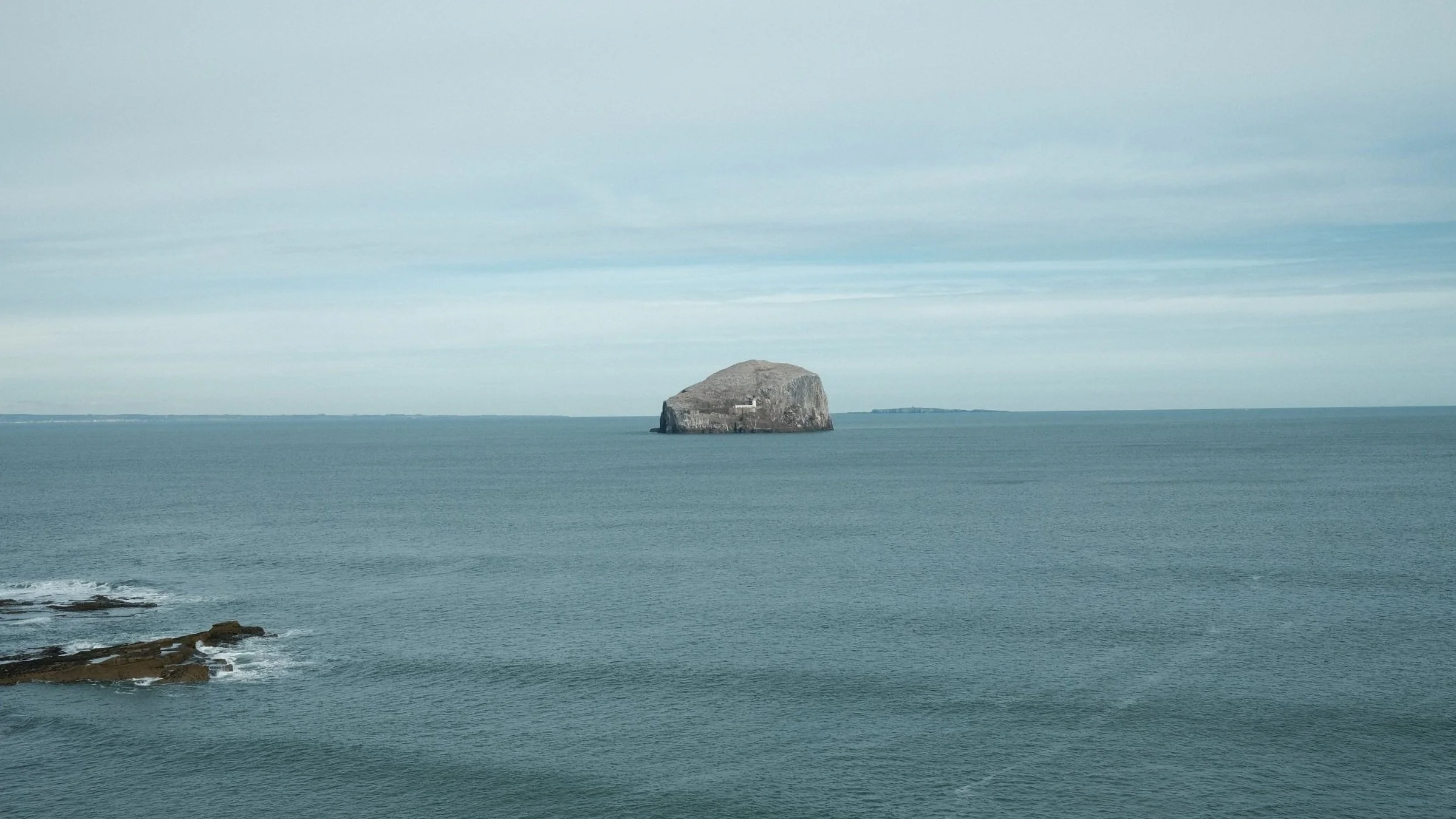 Bass Rock off the coast of North Berwick, East Scottish Boarder. Lighthouse, puffins and sea birds. Rocks and waves. Taken on a Fujifilm X100V with a Portra 400 inspired film look edit.