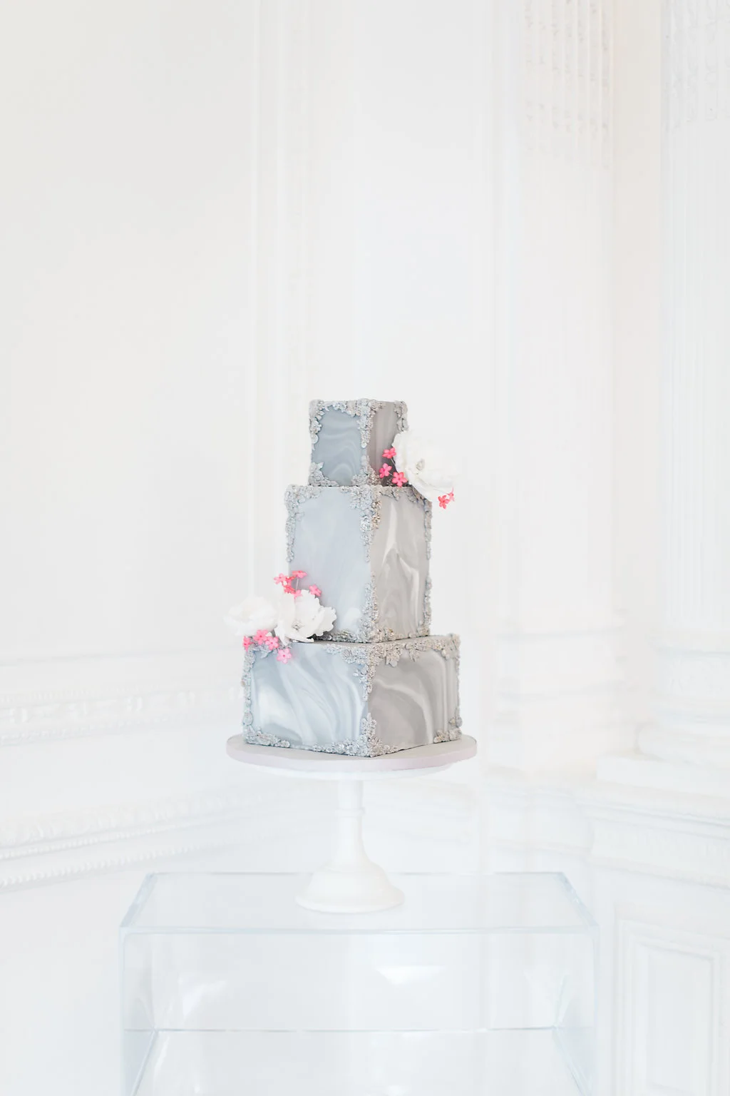 Arianna from Wildflower Cakes took the brief of classic and contemporary and ran with it - displaying her grey marbled tiers with neon pink florals on a perspex plinth.