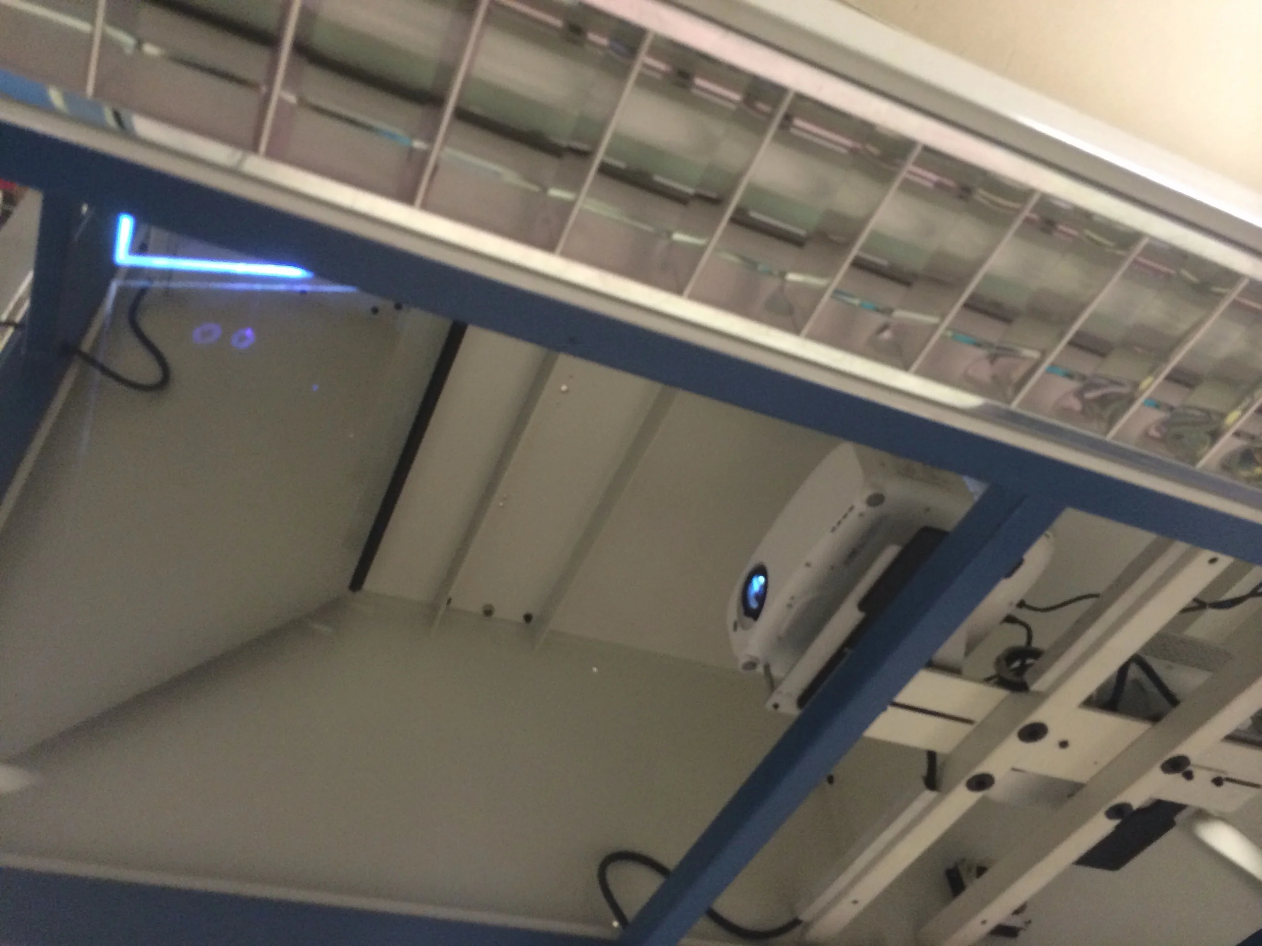 The projector is bouncing the image on the mirror/glass top left
