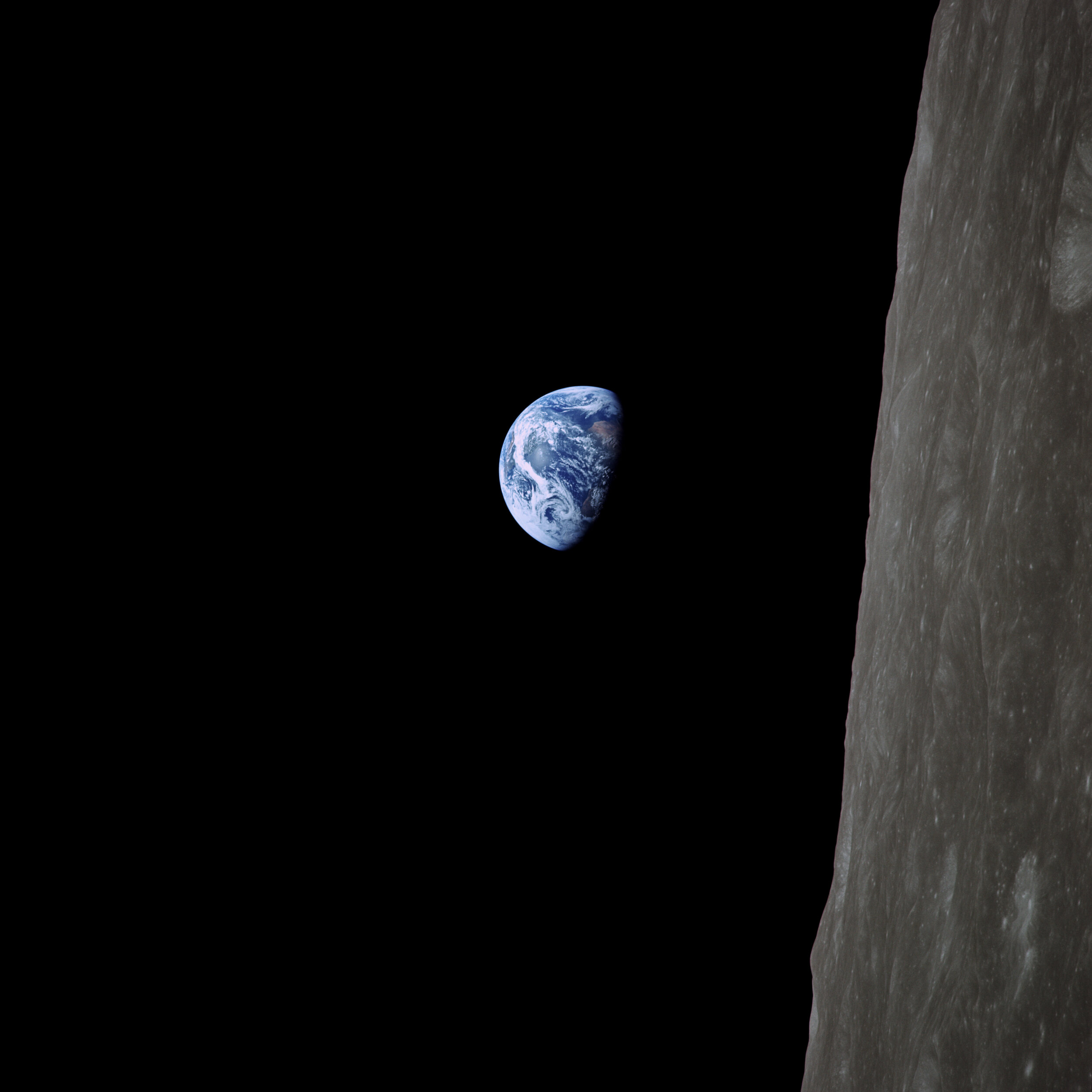  Apollo 8 — ‘Earthrise'  One of the most famous photographs of all time, it was taken by Bill Anders and is the first colour earthrise.  It is displayed here it is in its original orientation, with North up. We can see night falling across Africa and