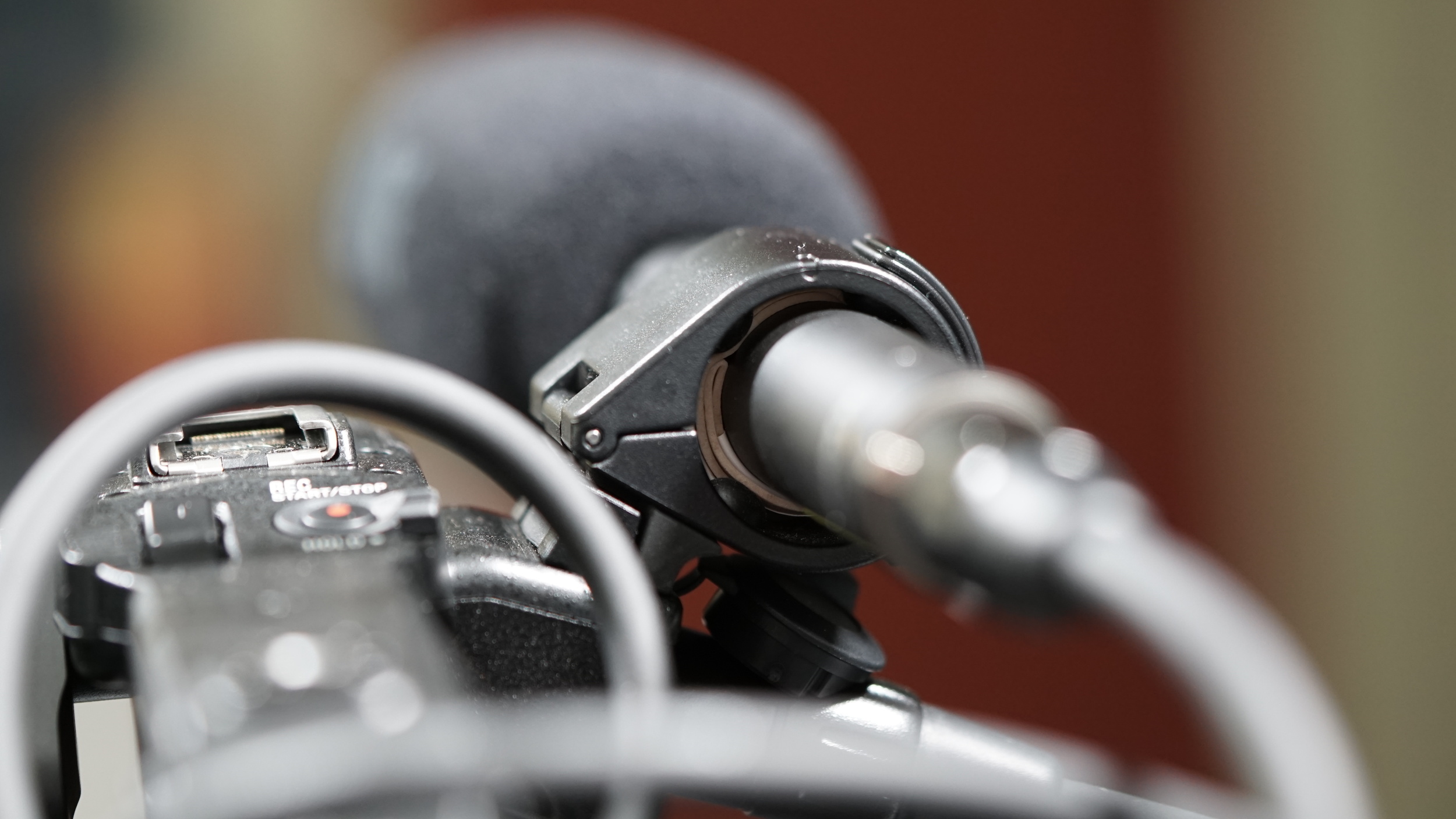 Three fat rubber bands and some tape allowed the RØDE NTG4+ to fit snugly inside the Sony's mic clamp. There's got to be a more elegant solution.