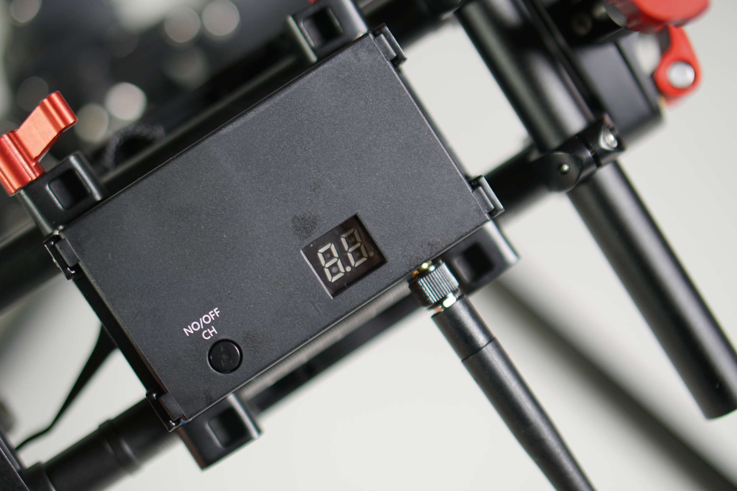 The 5.8Ghz transmitter is mounted to the bottom of the gimbal, underneath the QR plate. 
