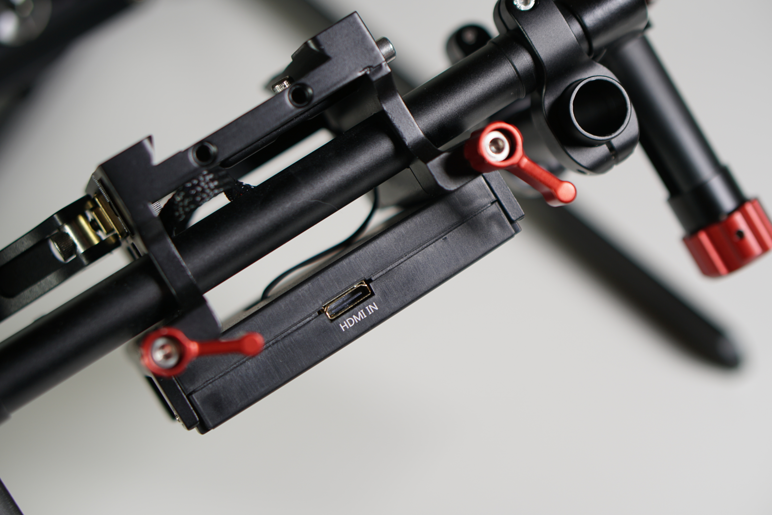 You run an HDMI cable from the camera to the transmitter, which has a mini-HDMI port.