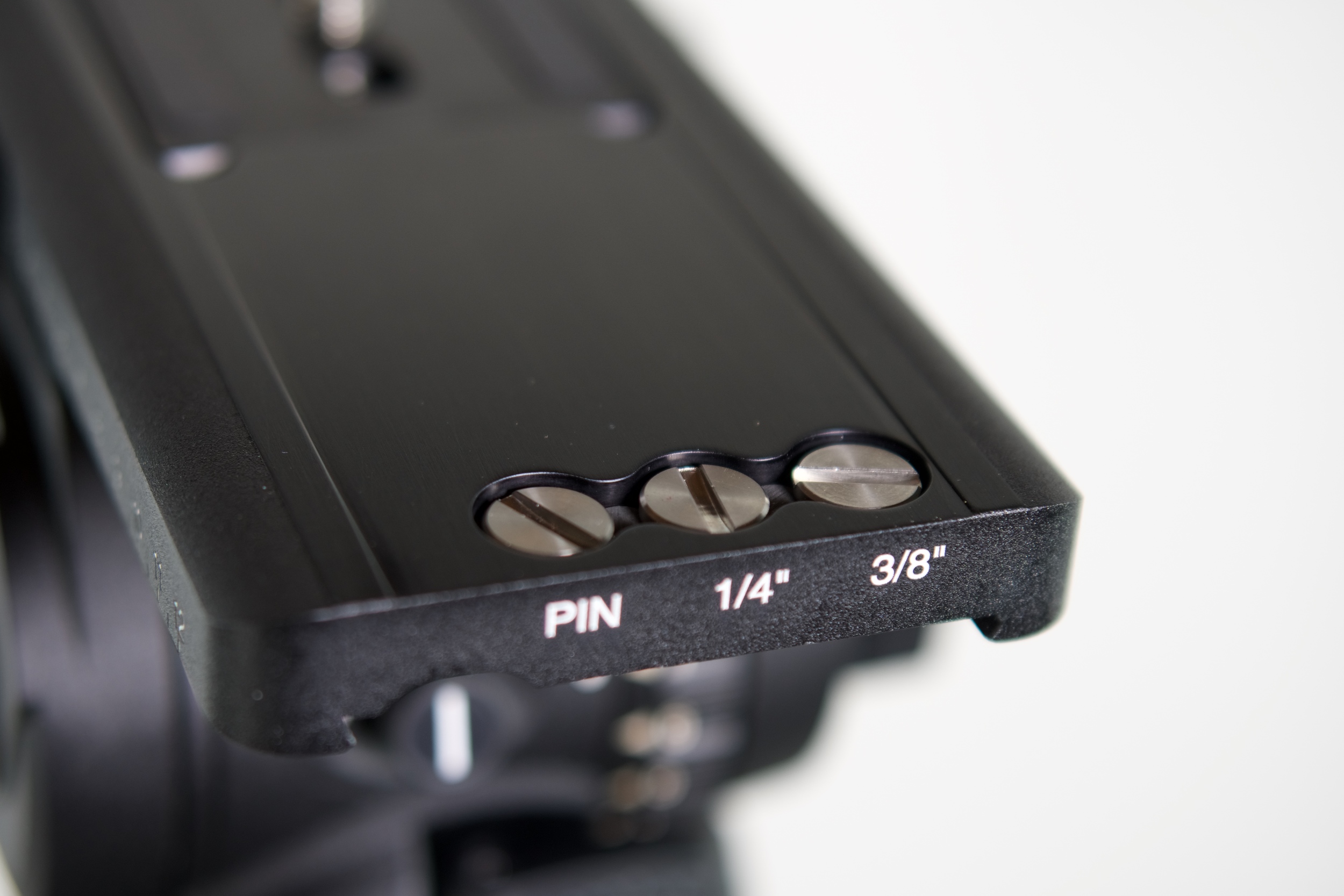 The design team knew that tripod screws get lost, so they added three threaded holes at the end of the base into which the camera plate locks and include 3/8", 1/4" and pin replacements