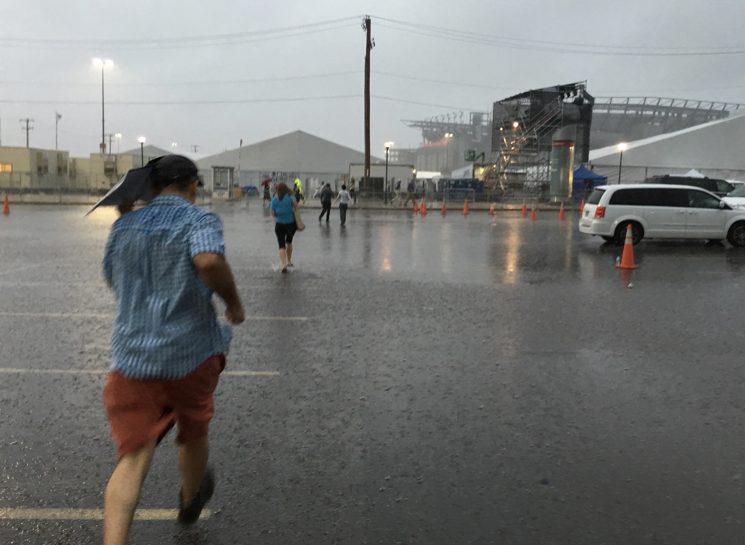 Racing through flash flood from the bus to the security tent at the DNC. iPhone 6s+ ISO 40, f/2.2, 1/15. Out in a jiffy, I didn't mind that it got wet. It was just fine. I think the Schneider iPro case helped.