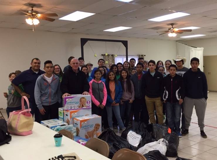 This is Brother Dennis Carrol with the youth that went on the mission trip in 2015. Missionary Carrol is standing behind the boxes of pampers.