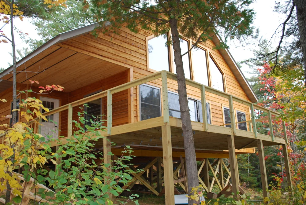 Cabin 26, a two-story cabin under old-growth pines and cedars