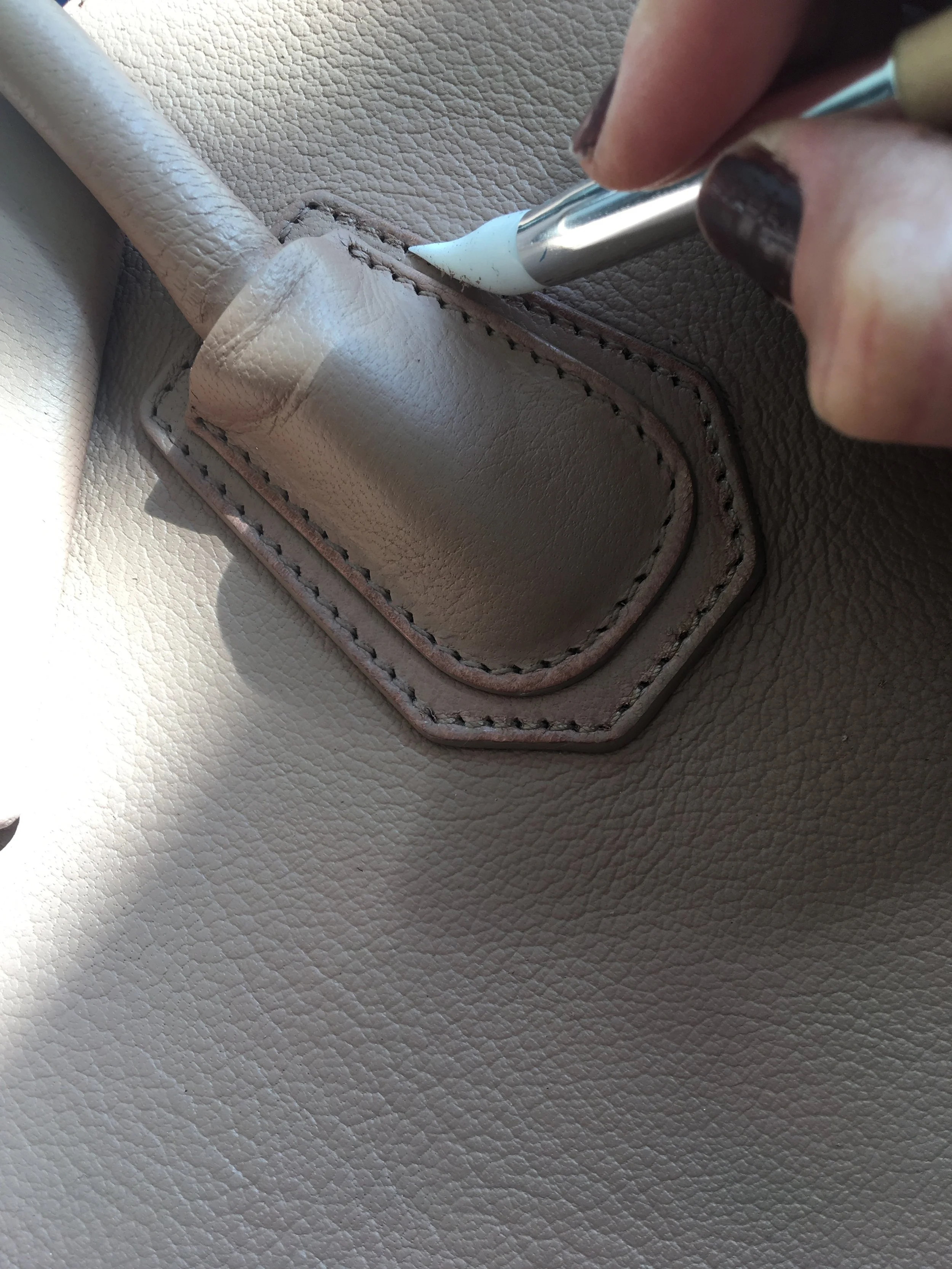 Removing the paint that had been painted over the stitching