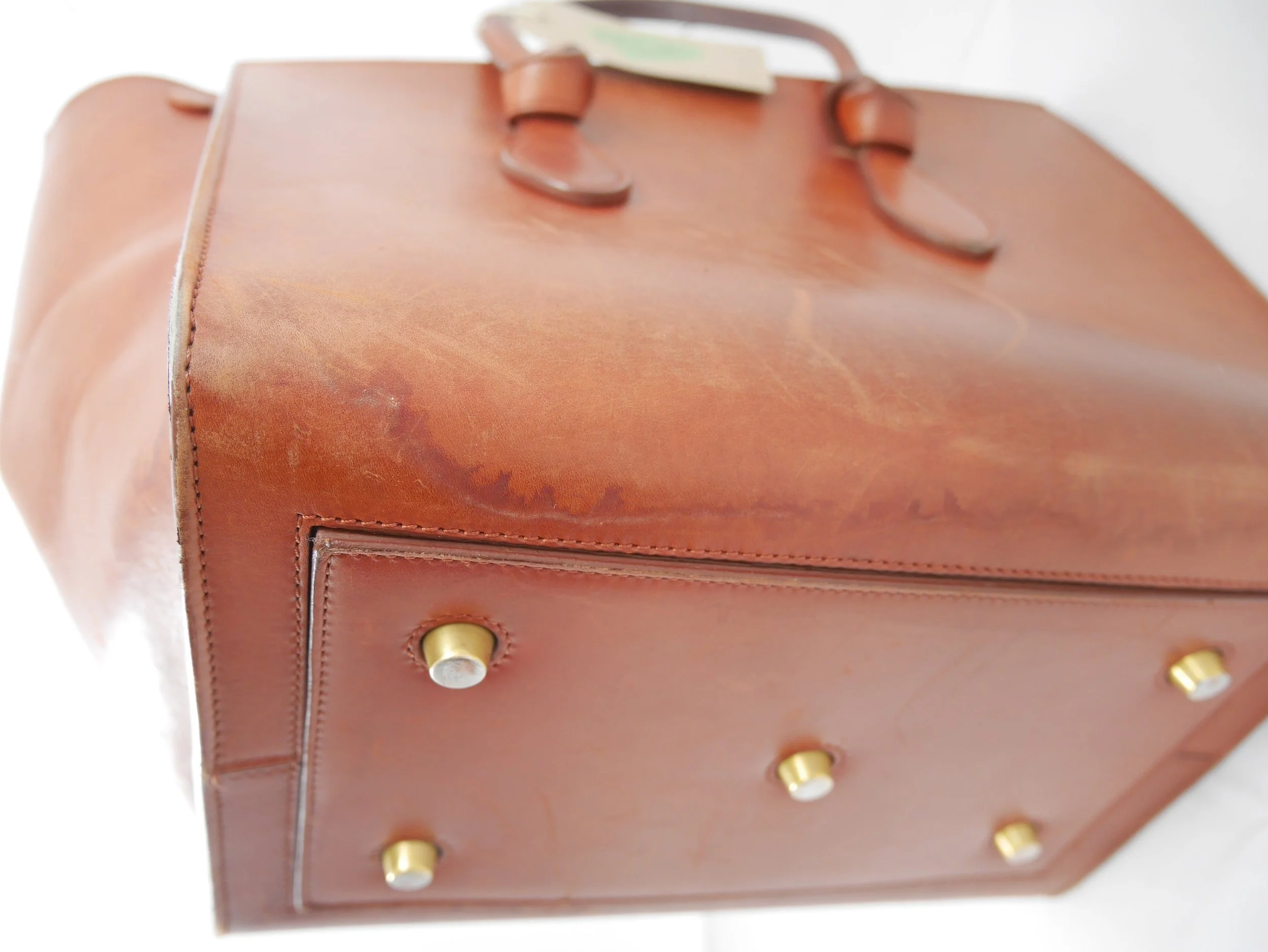 Before: visible watermarks on leather exterior