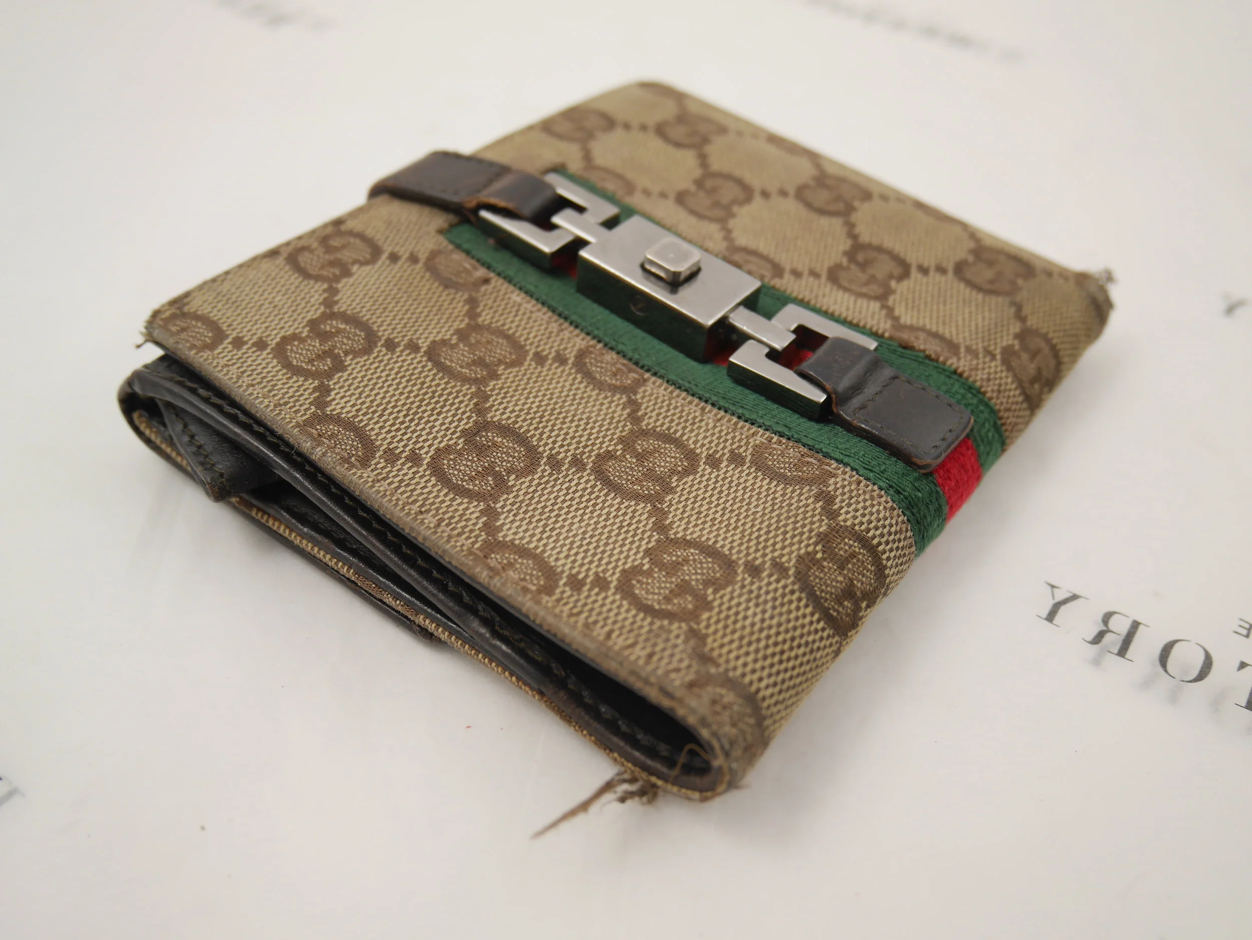 Before: frayed corners on the Gucci wallet