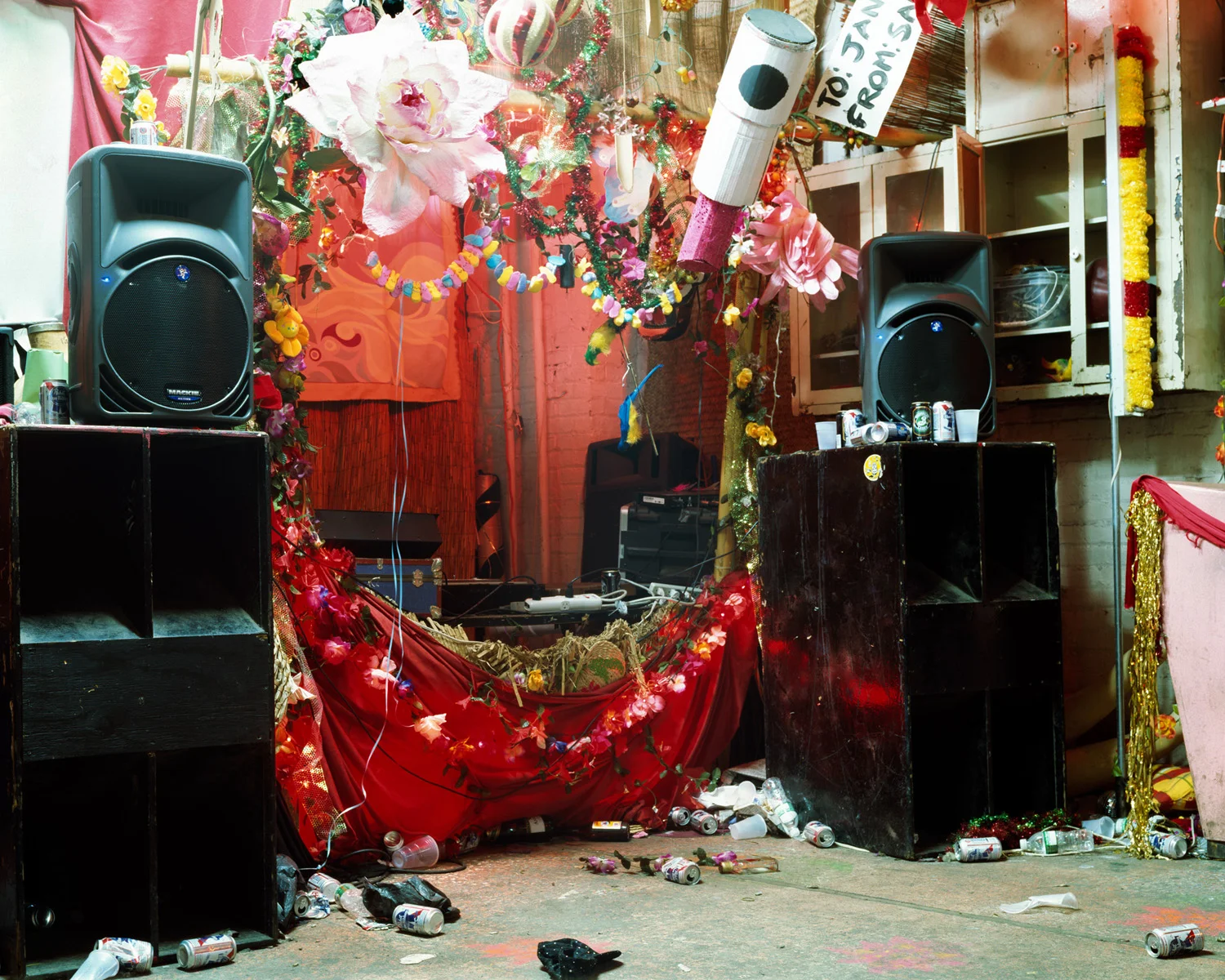 These images were made in loft spaces in Brooklyn after huge parties and art events. I revel in the lushness of what is left behind in these makeshift spaces that are true labors of love by their creators, and the little mysteries that they reveal. There is a tension created between happiness and sadness: an elaborately decorated DJ booth, crushed empty cups strewn about the floor, and large, silent, black speakers amongst traces of a celebration, with no celebration to be seen. It is the after and the in-between that interest me most and It is here that the conversation happens for me.