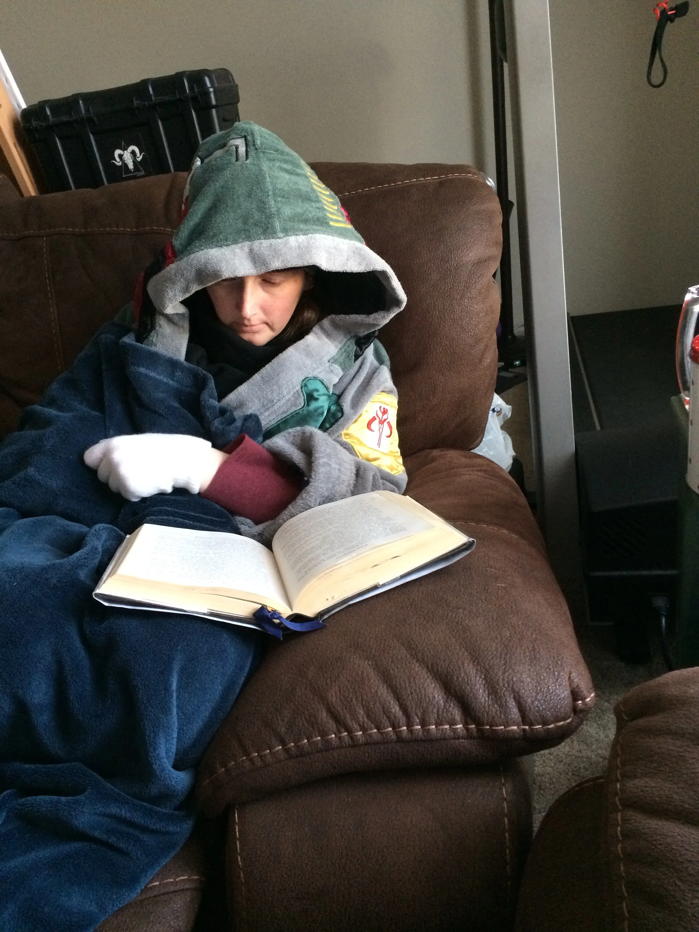 Ahh, the coziness of being bundled up, reading a book. Or, am I "miming" reading a book? With white gloves, it's hard to be sure.