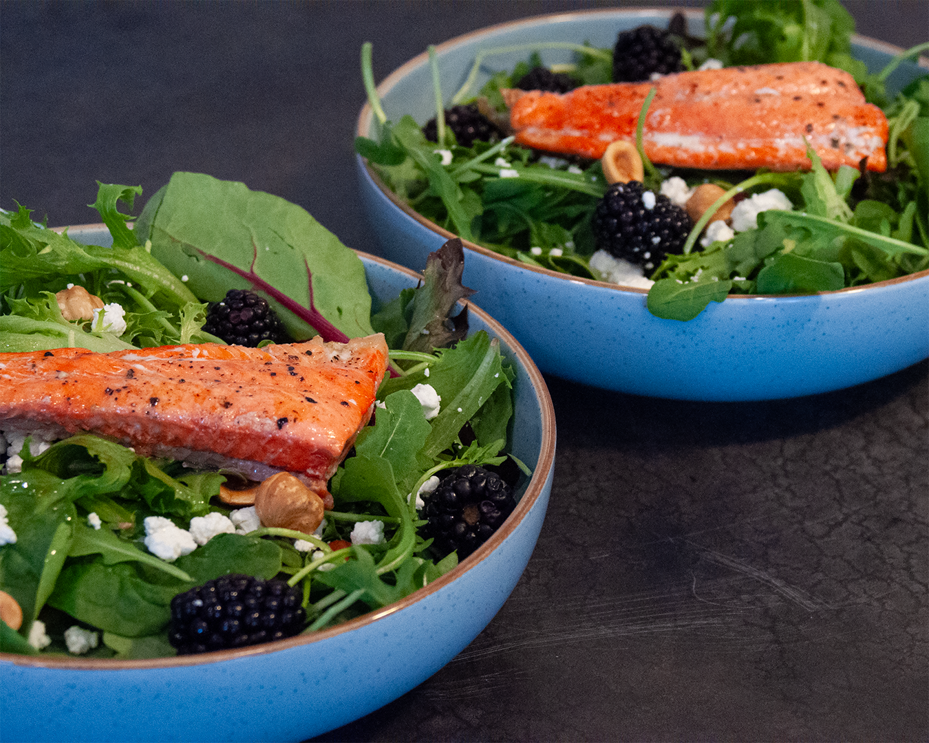 Seattle Salad with salmon, blackberries, hazelnuts and goat cheese over mixed greens