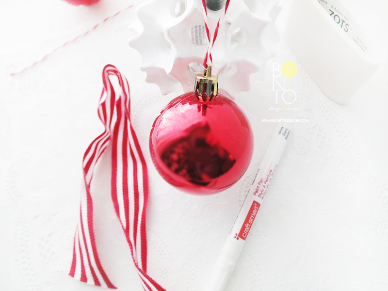 Dec. 3 DIY ORNAMENT: Simple and Unique. All the essentials used here are from MICHAELS . One stop shop for this fun project! (Red and White) Ribbon, (Red) Solid Ornaments, Glue Dots and Craftsmart Pen.