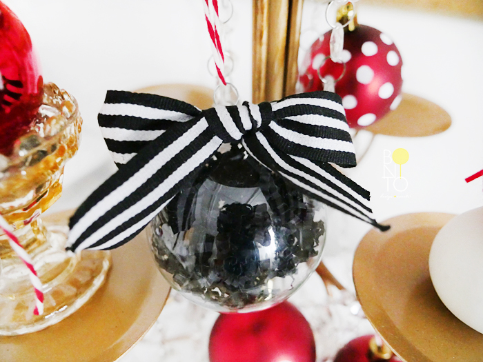 DIY Ornament. For this one I filled a clear ornament with black crinkle paper and used a glue dot to add a striped bow. Click HERE to see previous DIY ornament ideas.