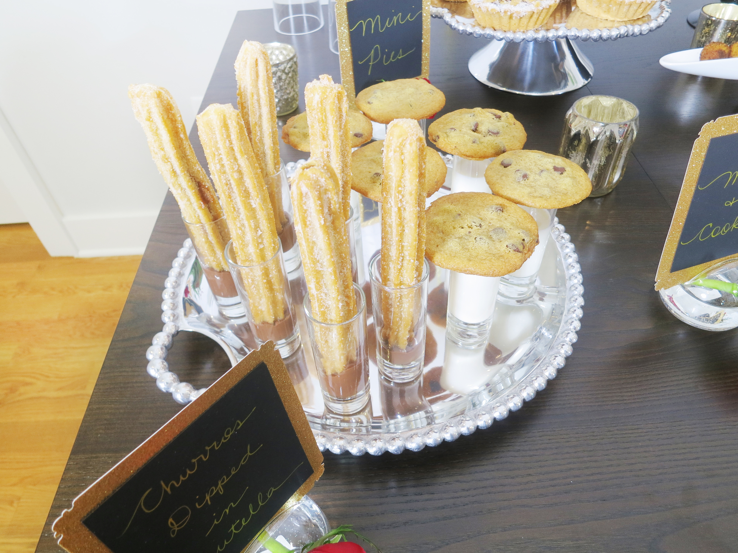 Yummy Churros Dipped in Nutella, Mini Pies, Milk and Cookies will definitely have your guests gaga.